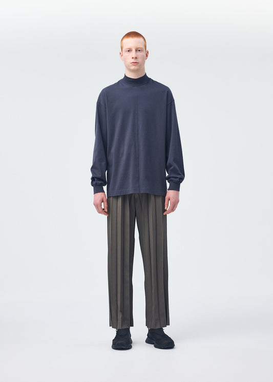 A model wears the HOMME PLISSÉ ISSEY MIYAKE Black Turtleneck Top top.