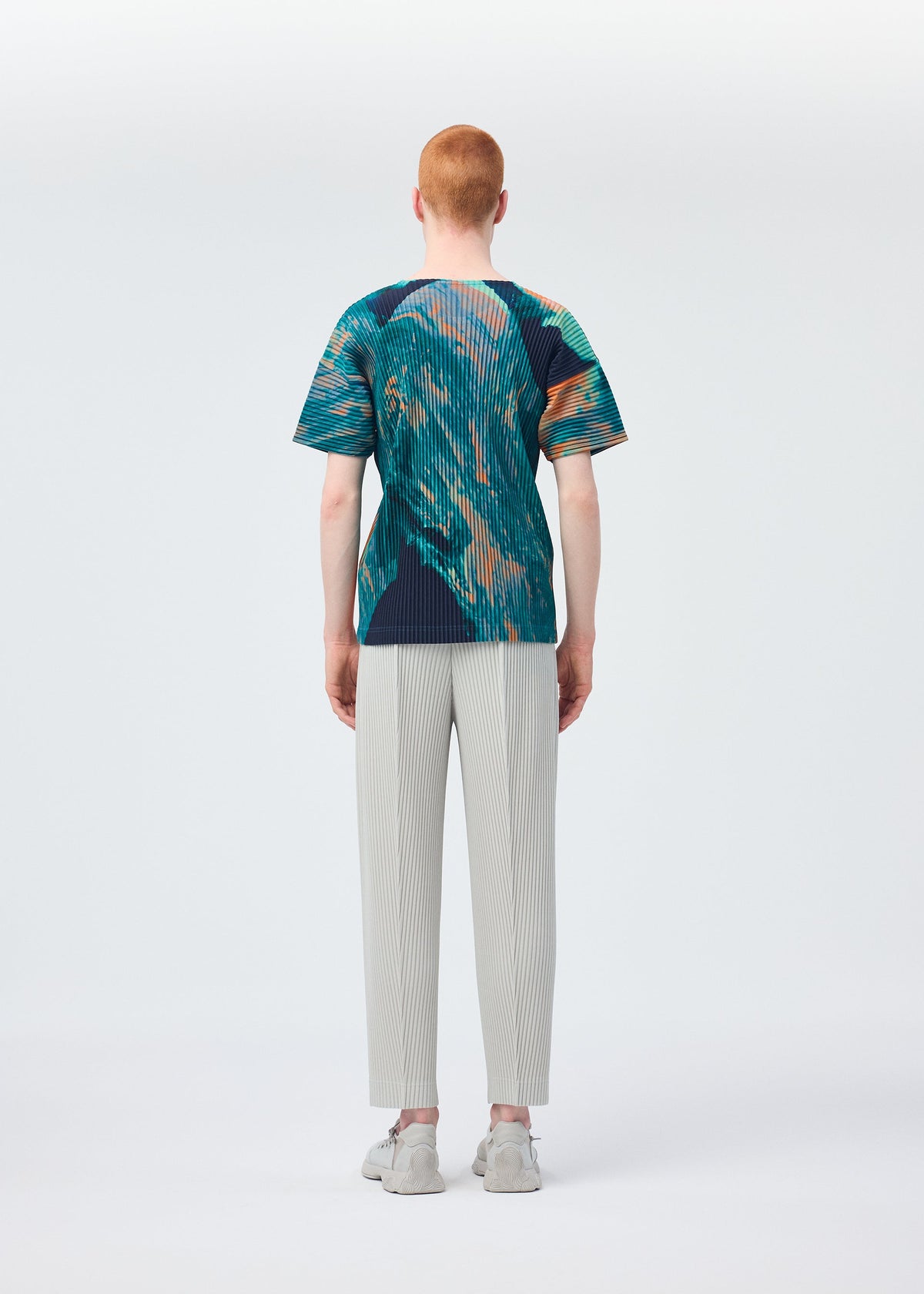 A model wears the HOMME PLISSÉ ISSEY MIYAKE AGATE top.
