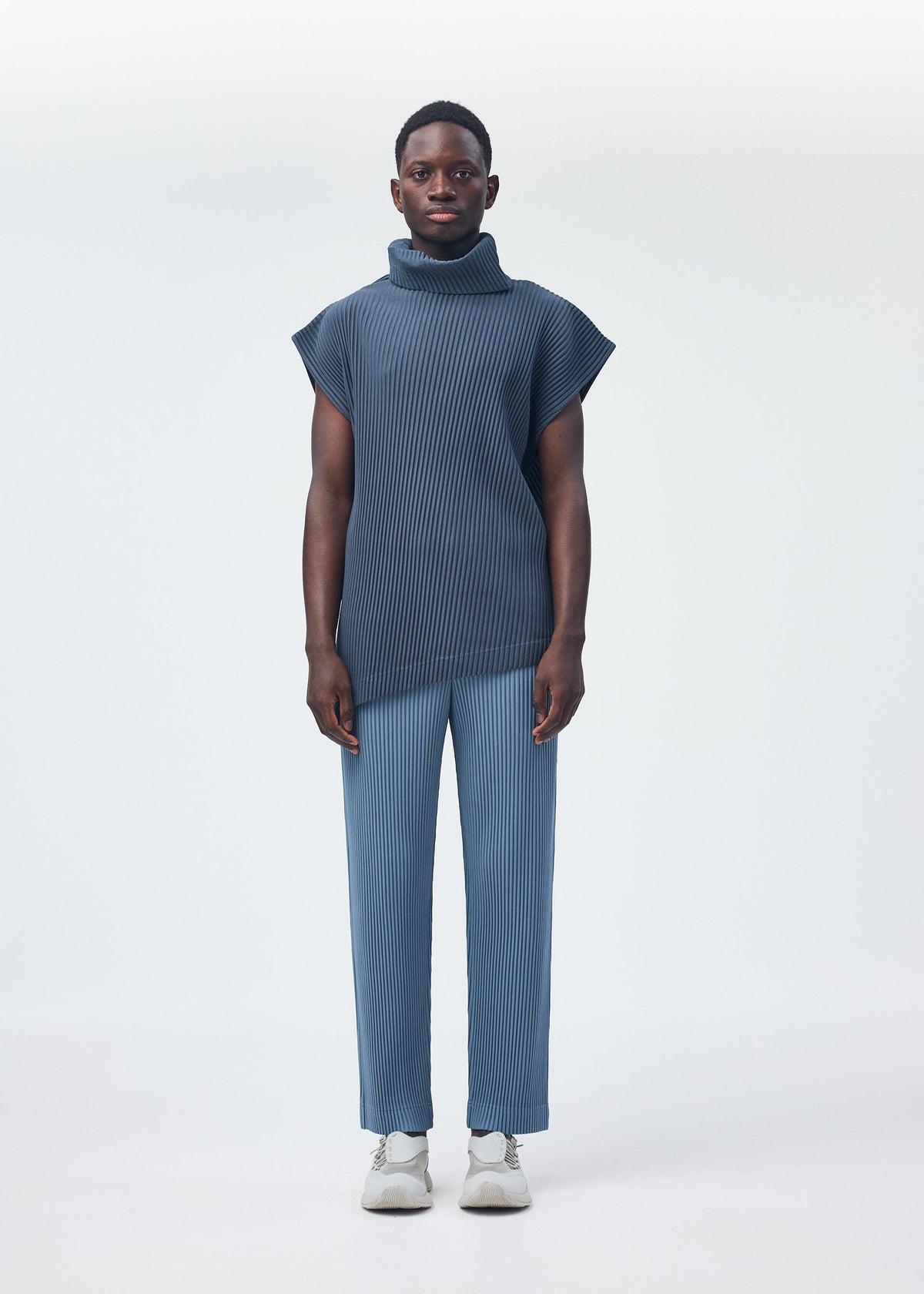 A model wears the HOMME PLISSÉ ISSEY MIYAKE ANGULAR STONE top.