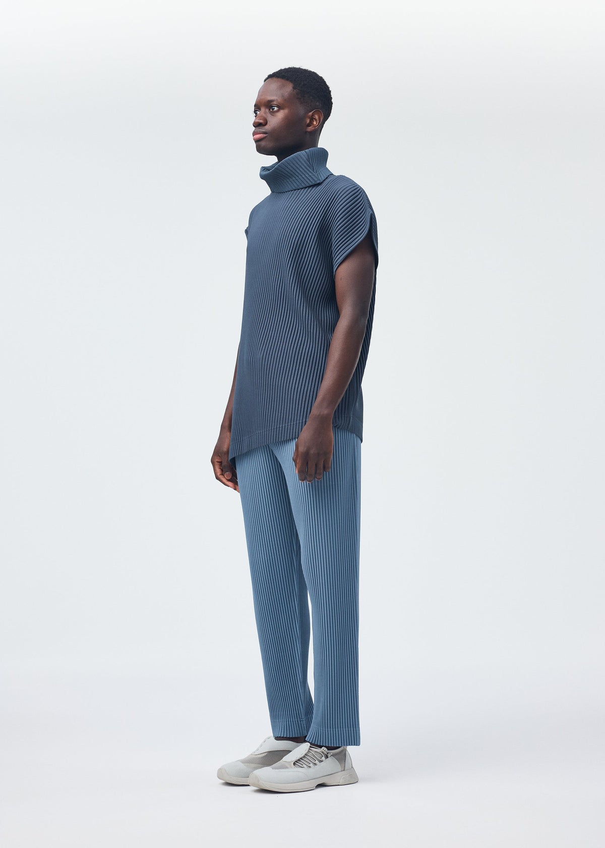 A model wears the HOMME PLISSÉ ISSEY MIYAKE ANGULAR STONE top.