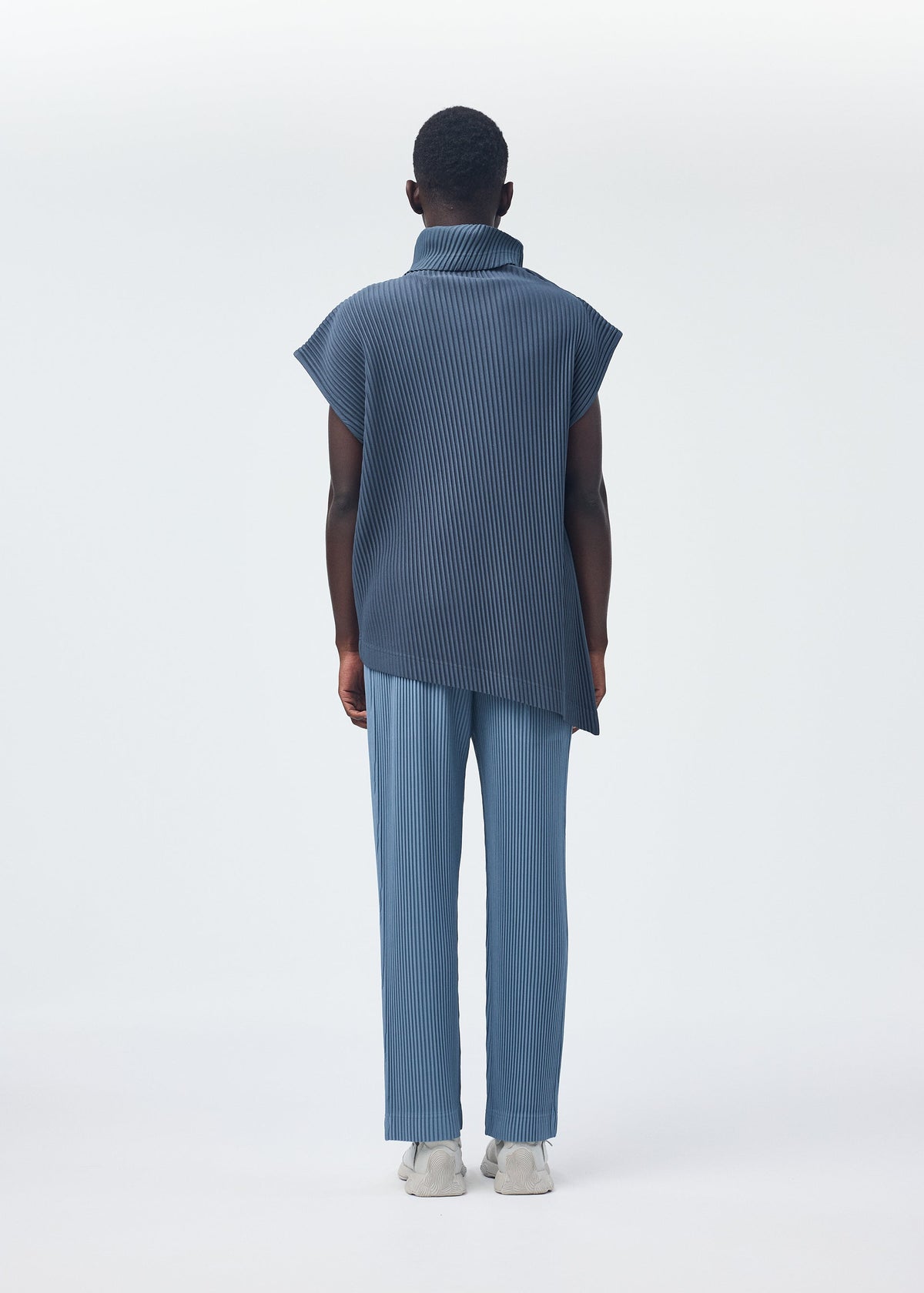 A model wears the HOMME PLISSÉ ISSEY MIYAKE ANGULAR STONE top.