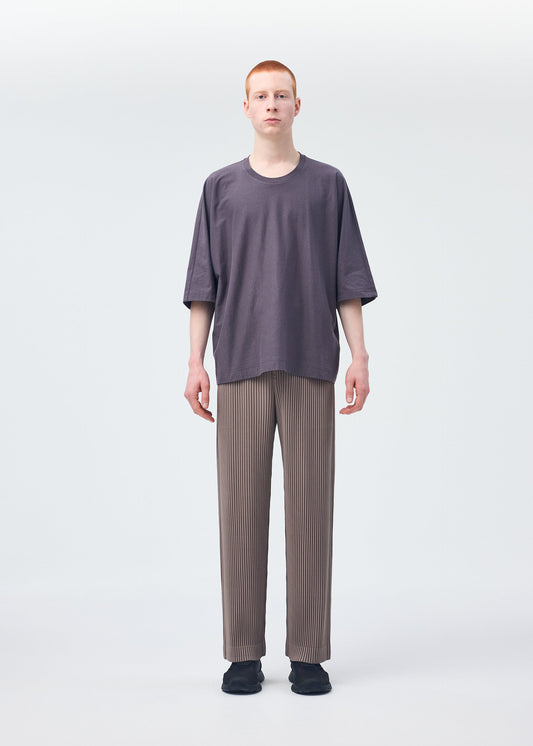A model wears the HOMME PLISSÉ ISSEY MIYAKE RELEASE T 1 top.