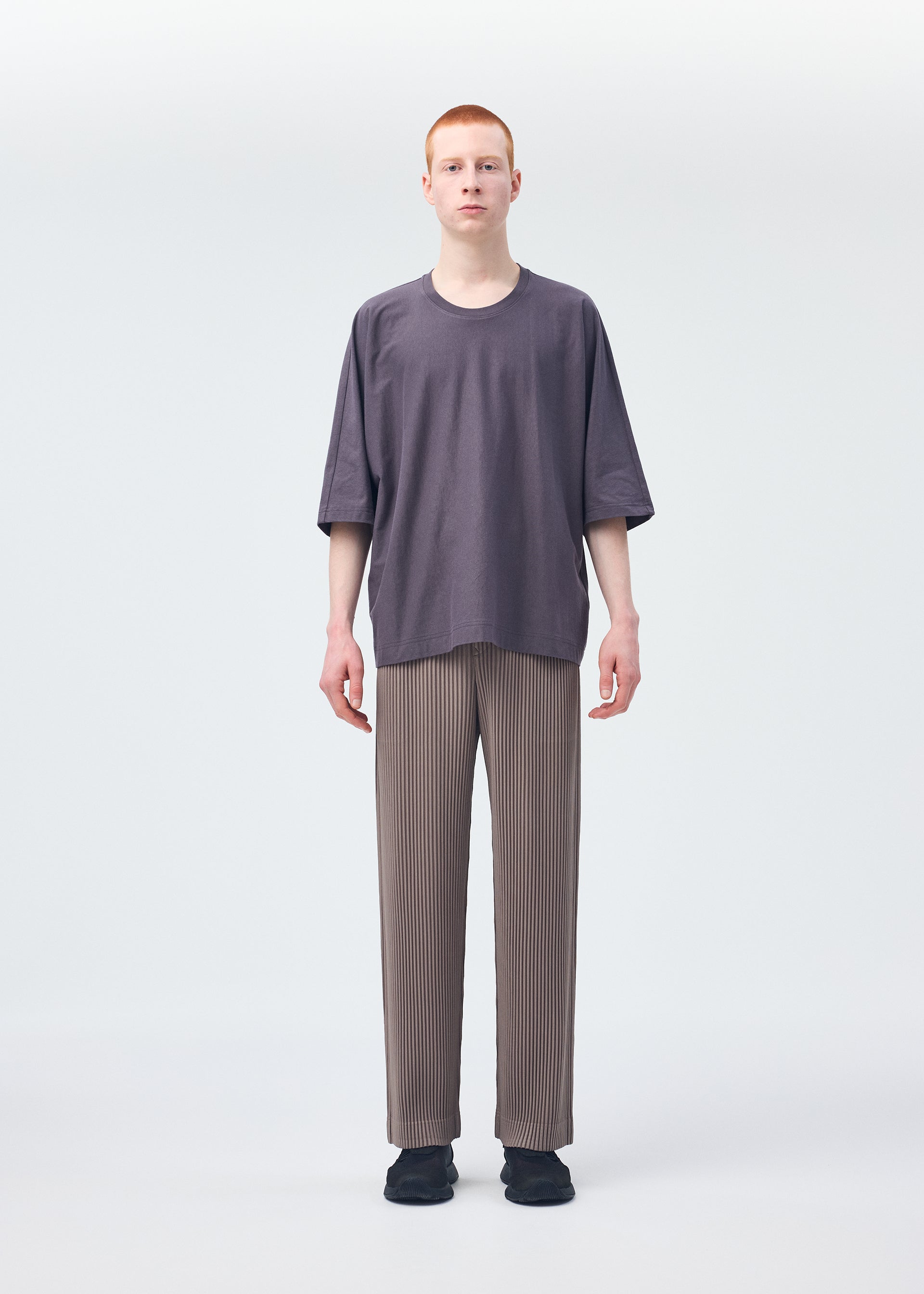 A model wears the HOMME PLISSÉ ISSEY MIYAKE RELEASE T 1 top.