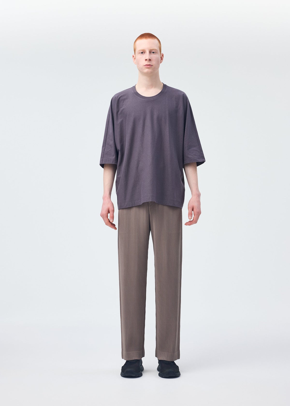 A model wears the HOMME PLISSÉ ISSEY MIYAKE RELEASE T 1 top.
