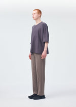 A model wears the HOMME PLISSÉ ISSEY MIYAKE RELEASE T 1 top.