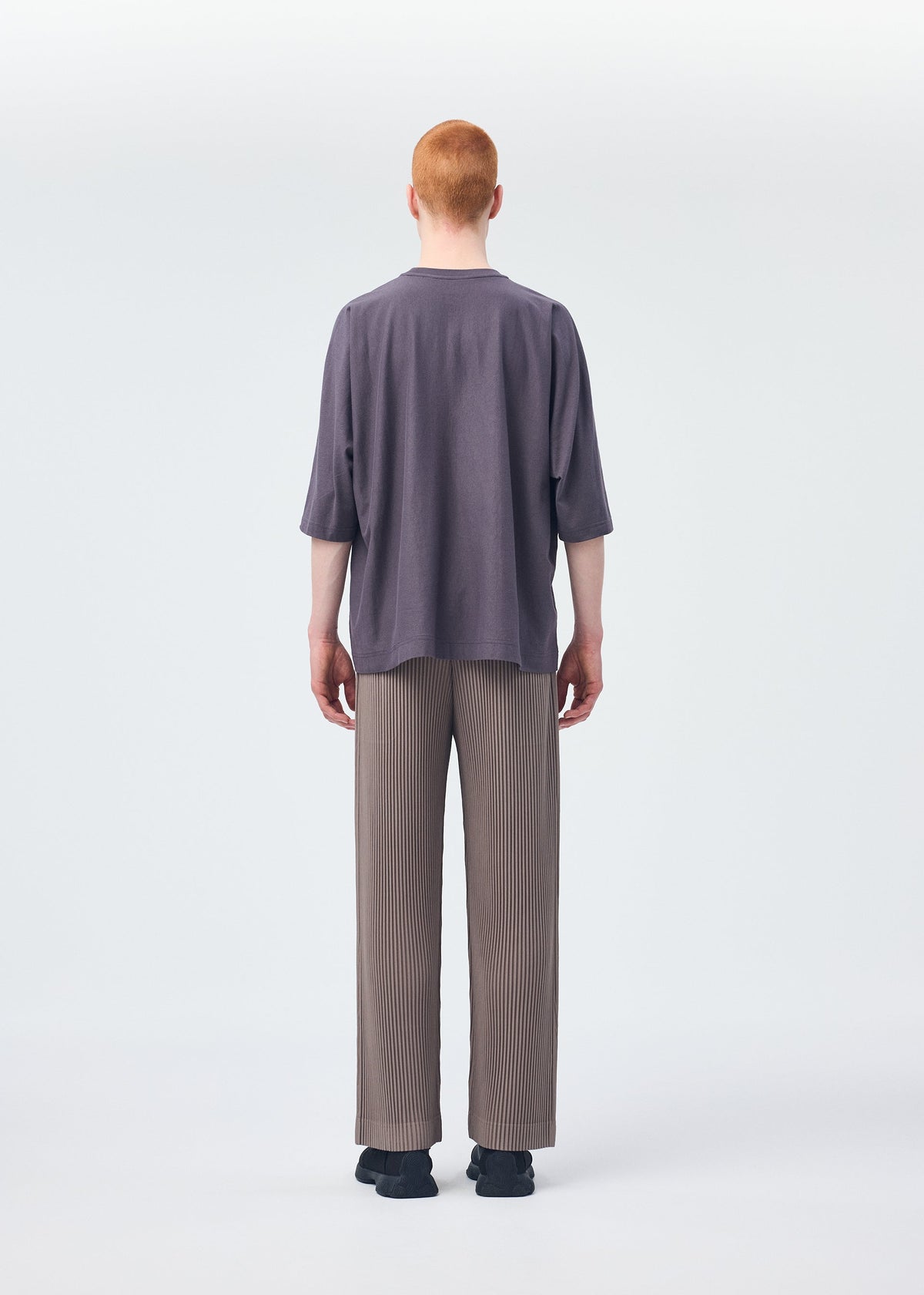 A model wears the HOMME PLISSÉ ISSEY MIYAKE RELEASE T 1 top.