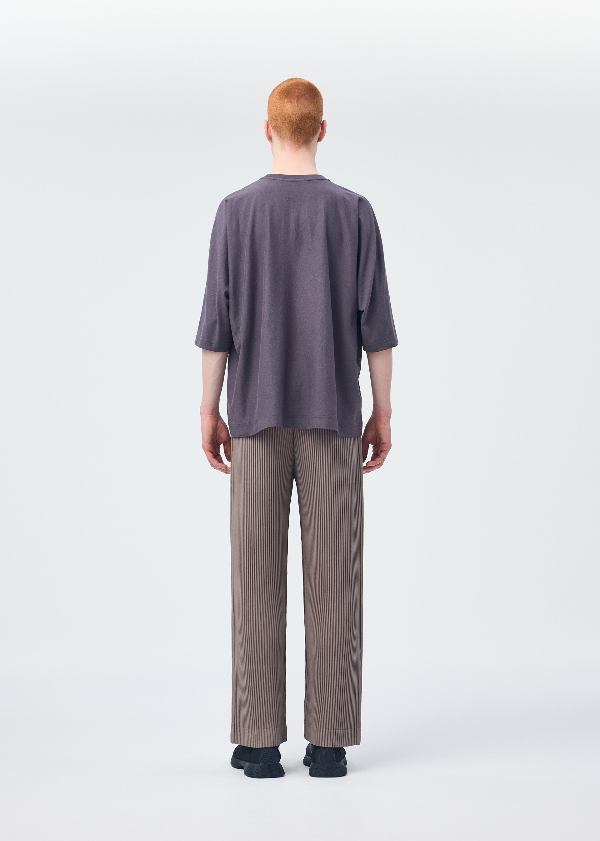 A model wears the HOMME PLISSÉ ISSEY MIYAKE RELEASE T 1 top.