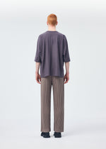 A model wears the HOMME PLISSÉ ISSEY MIYAKE RELEASE T 1 top.