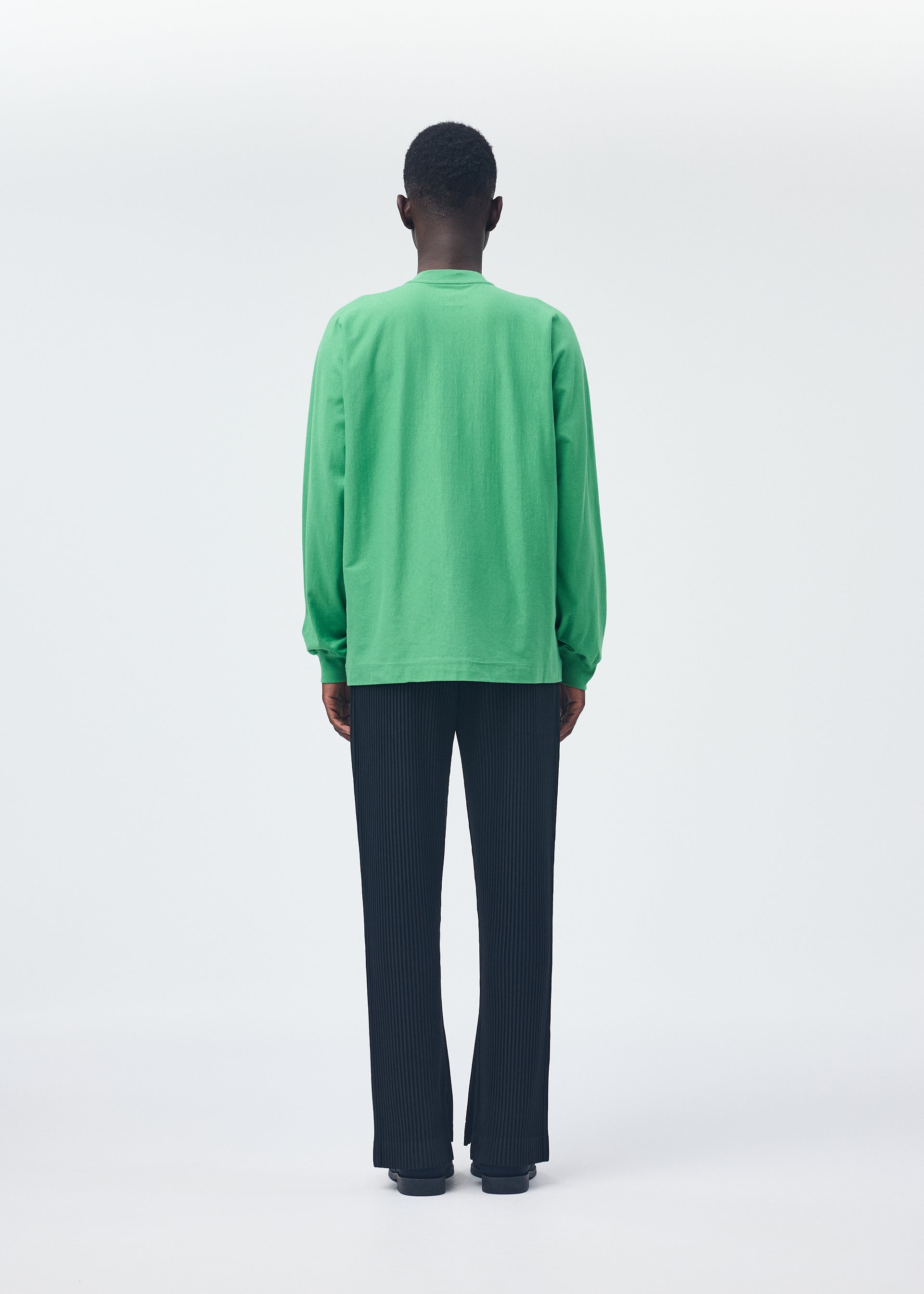 A model wears the HOMME PLISSÉ ISSEY MIYAKE RELEASE T 1 top.
