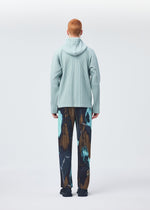 A model wears the HOMME PLISSÉ ISSEY MIYAKE MONTHLY COLORS JULY shirt.
