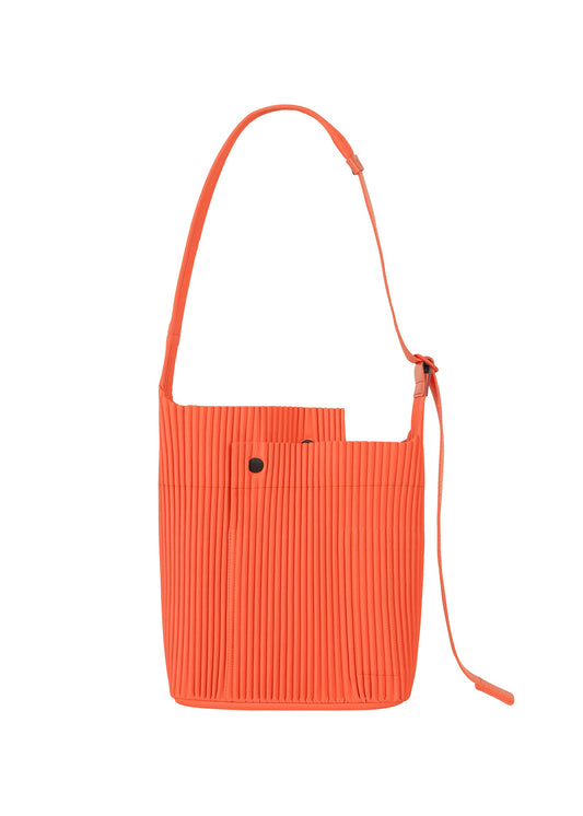 A product shot of the HOMME PLISSÉ ISSEY MIYAKE UTILITY bag in portofino buoy orange (33).