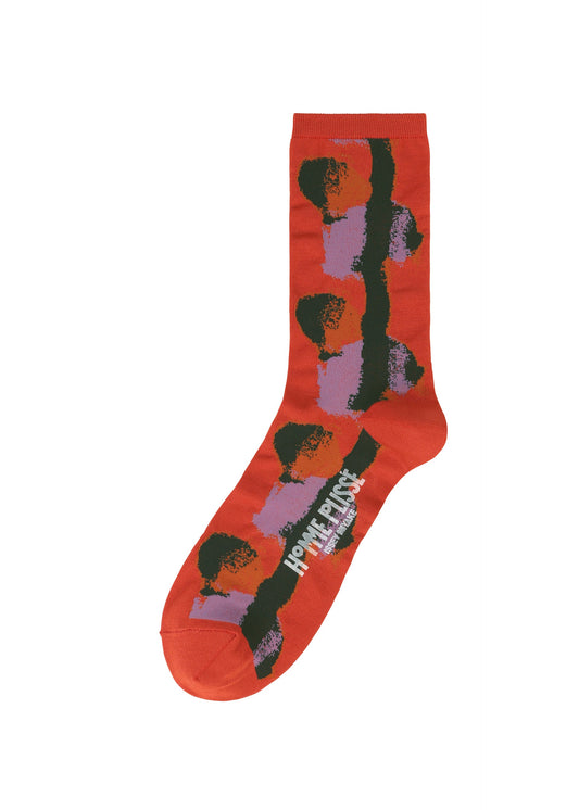 A product shot of the HOMME PLISSÉ ISSEY MIYAKE DAWN SOCKS socks in red (24).