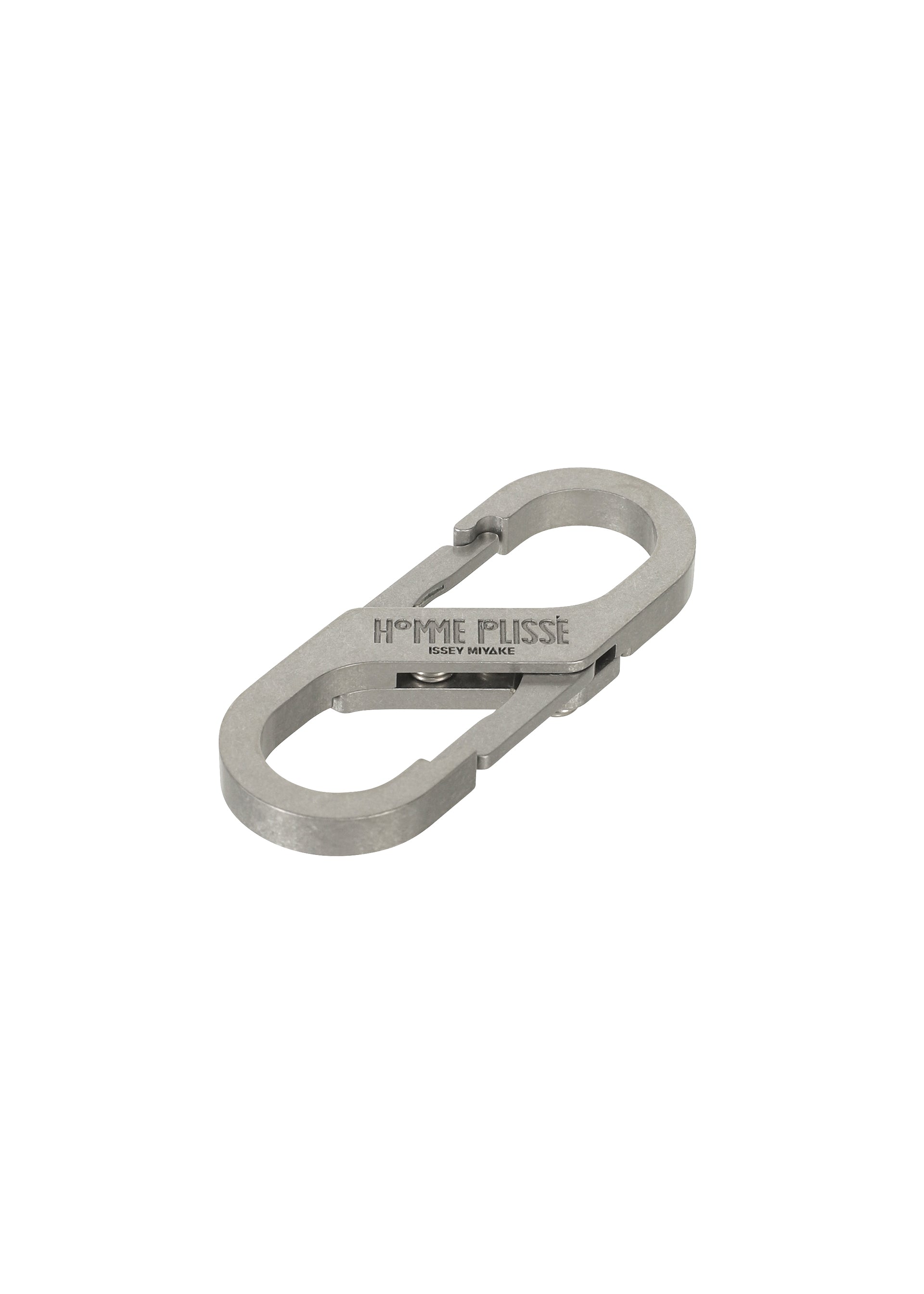 A detail shot of the HOMME PLISSÉ ISSEY MIYAKE CARABINER jewellery.