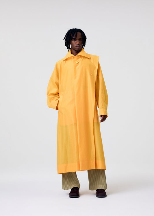 A model wears the HOMME PLISSÉ ISSEY MIYAKE CRYSTALLINE WOOL BLEND coat.