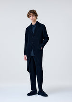 A model wears the HOMME PLISSÉ ISSEY MIYAKE TUXEDO PLEATS jacket.