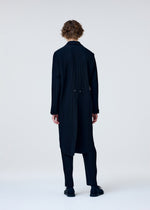 A model wears the HOMME PLISSÉ ISSEY MIYAKE TUXEDO PLEATS jacket.