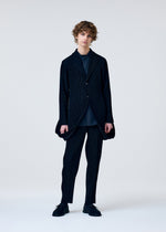 A model wears the HOMME PLISSÉ ISSEY MIYAKE TUXEDO PLEATS jacket.