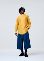 A model wears the HOMME PLISSÉ ISSEY MIYAKE EDGE ENSEMBLE trousers.