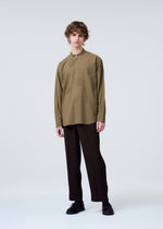 A model wears the HOMME PLISSÉ ISSEY MIYAKE TUXEDO PLEATS trousers.