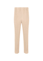 A product shot of the HOMME PLISSÉ ISSEY MIYAKE TUXEDO PLEATS trousers in beige (40).
