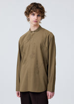A model wears the HOMME PLISSÉ ISSEY MIYAKE EMBROIDERY PRESS SHIRT shirt.