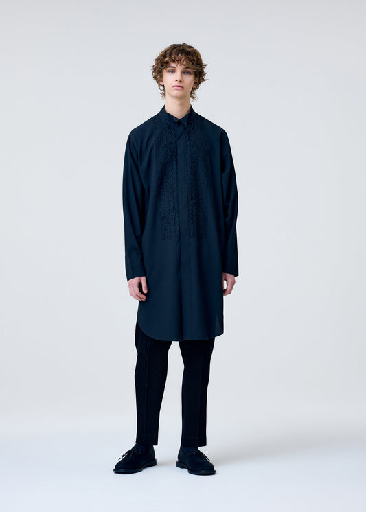 A model wears the HOMME PLISSÉ ISSEY MIYAKE EMBROIDERY PRESS SHIRT shirt.