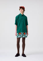 A model wears the HOMME PLISSÉ ISSEY MIYAKE PL RAMIE SHIRT shirt.