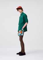 A model wears the HOMME PLISSÉ ISSEY MIYAKE PL RAMIE SHIRT shirt.