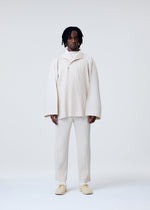 A model wears the HOMME PLISSÉ ISSEY MIYAKE WEAR OR WRAP jacket.