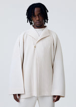 A model wears the HOMME PLISSÉ ISSEY MIYAKE WEAR OR WRAP jacket.