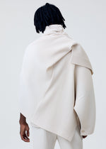 A model wears the HOMME PLISSÉ ISSEY MIYAKE WEAR OR WRAP jacket.