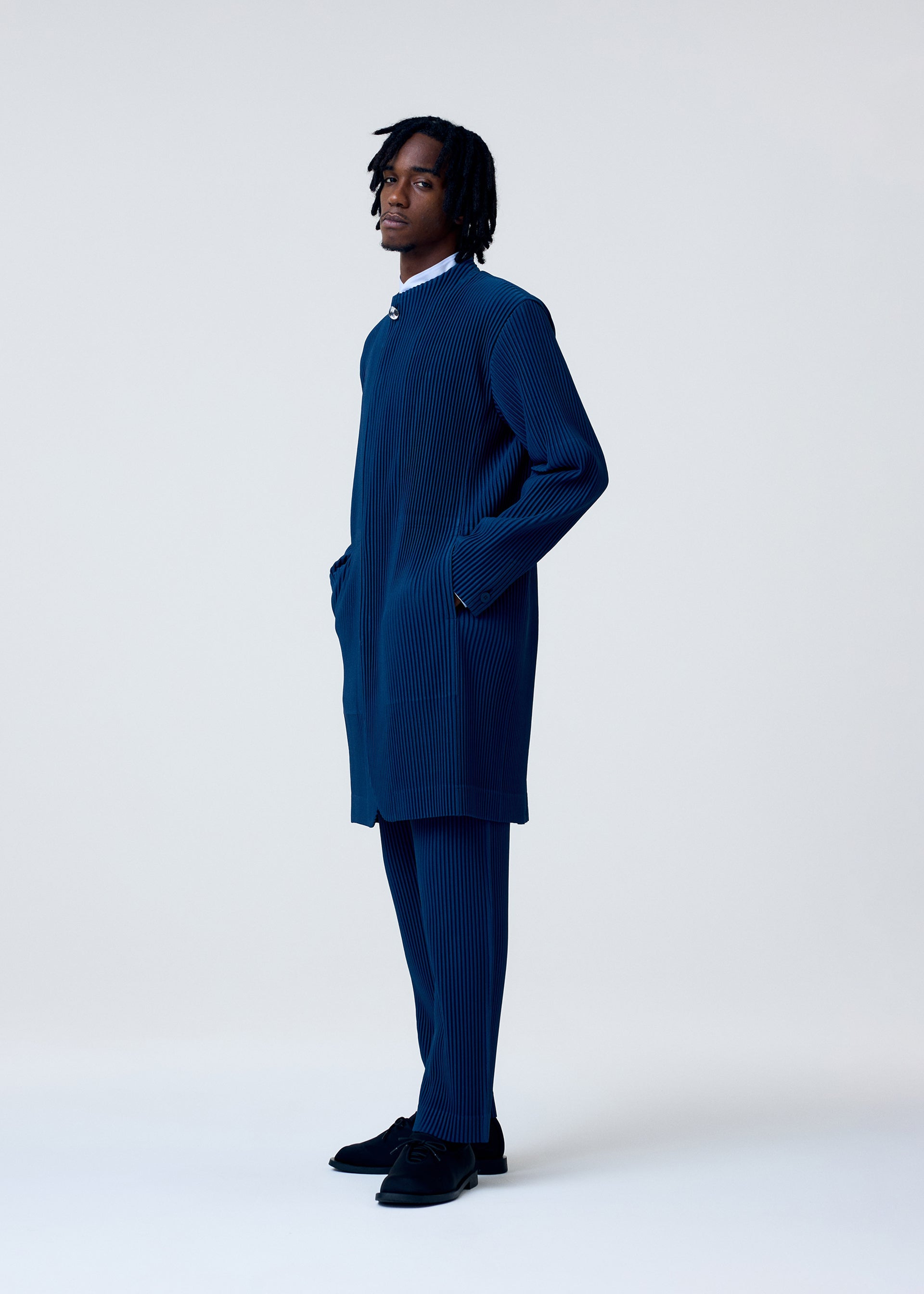 A model wears the HOMME PLISSÉ ISSEY MIYAKE TAILORED PLEATS 1 jacket.