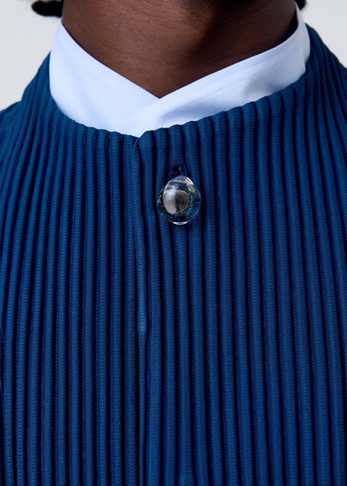 A model wears the HOMME PLISSÉ ISSEY MIYAKE TAILORED PLEATS 1 jacket.