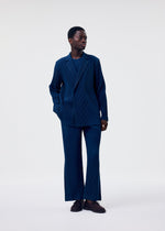 A model wears the HOMME PLISSÉ ISSEY MIYAKE TAILORED PLEATS 1 jacket.