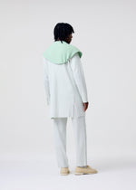 A model wears the HOMME PLISSÉ ISSEY MIYAKE TAILORED PLEATS 3 tailored-pleats-3-jacket-genova-metal-ochre-1.