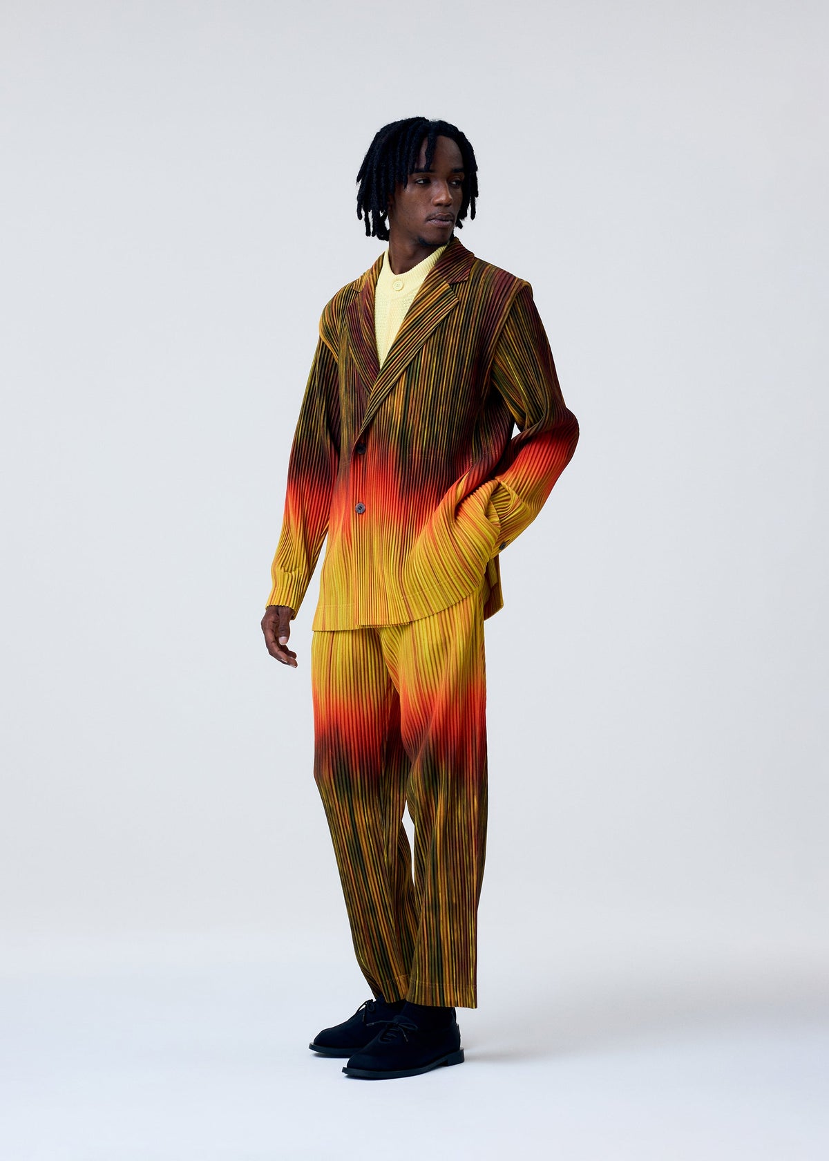 A model wears the HOMME PLISSÉ ISSEY MIYAKE PAINT BRUSH CLOSE UP jacket.