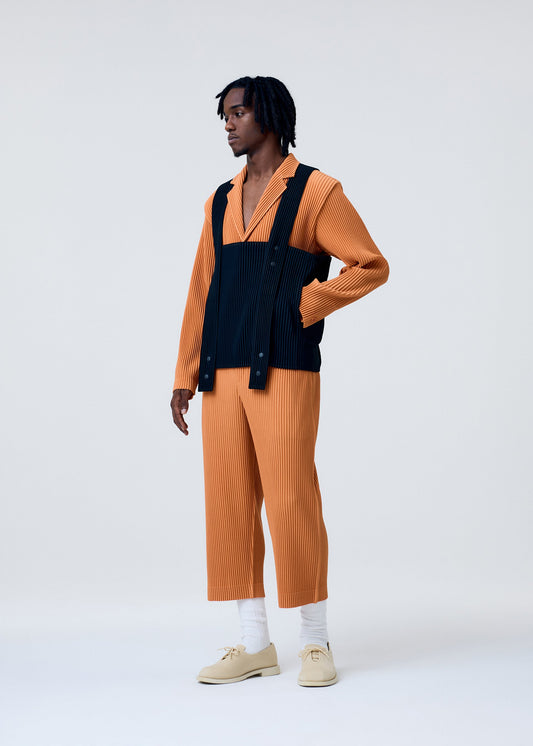 A model wears the HOMME PLISSÉ ISSEY MIYAKE PAINTER'S GEAR vest.