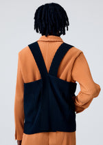 A model wears the HOMME PLISSÉ ISSEY MIYAKE PAINTER'S GEAR vest.