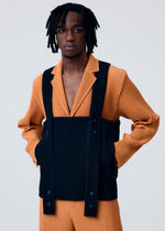 A model wears the HOMME PLISSÉ ISSEY MIYAKE PAINTER'S GEAR vest.