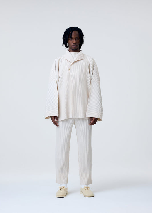 A model wears the HOMME PLISSÉ ISSEY MIYAKE MONTHLY COLORS MARCH trousers.