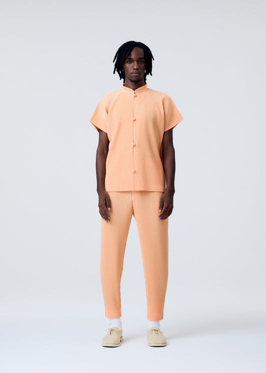 A model wears the HOMME PLISSÉ ISSEY MIYAKE MONTHLY COLORS APRIL trousers.