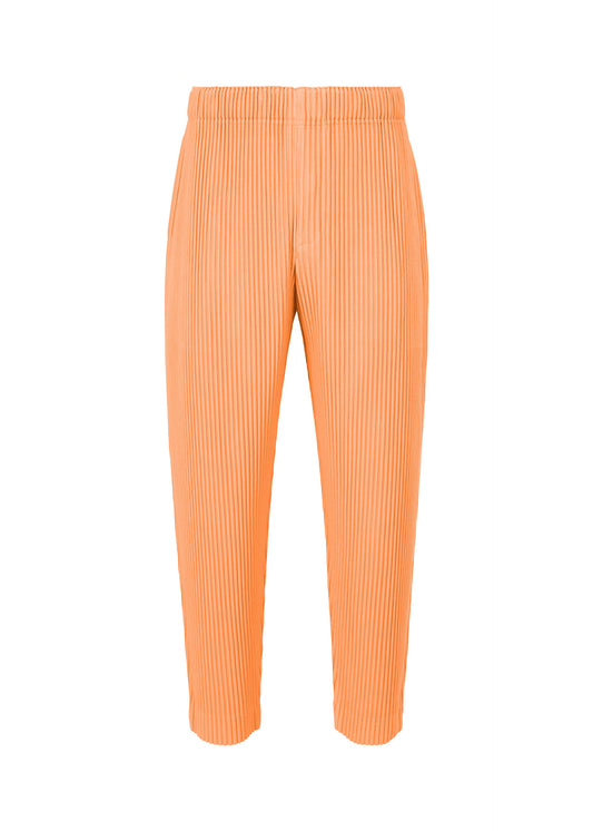 A product shot of the HOMME PLISSÉ ISSEY MIYAKE MONTHLY COLORS APRIL trousers in cinque terre orange (30).
