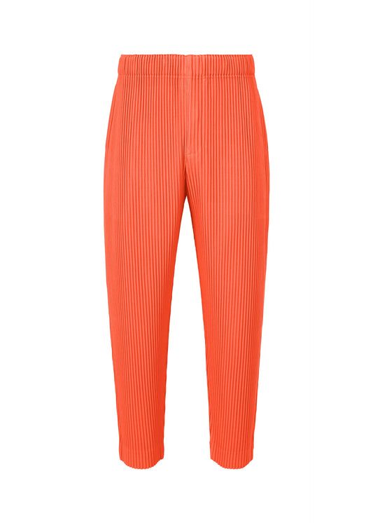 A product shot of the HOMME PLISSÉ ISSEY MIYAKE MONTHLY COLORS APRIL trousers in portofino buoy orange (33).