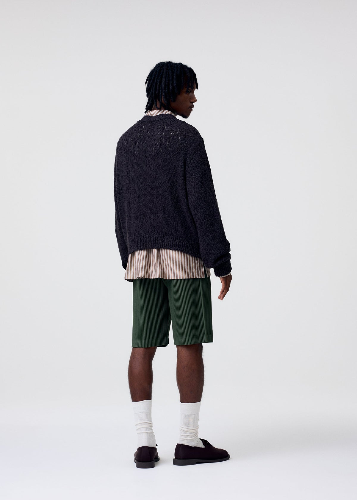 A model wears the HOMME PLISSÉ ISSEY MIYAKE COLOR PLEATS 2 shorts.