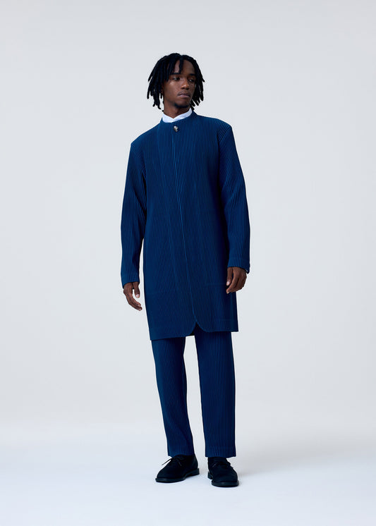 A model wears the HOMME PLISSÉ ISSEY MIYAKE TAILORED PLEATS 1 trousers.