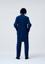 A model wears the HOMME PLISSÉ ISSEY MIYAKE TAILORED PLEATS 1 trousers.