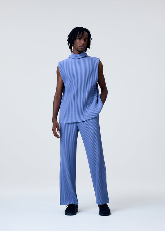 A model wears the HOMME PLISSÉ ISSEY MIYAKE TAILORED PLEATS 1 trousers.