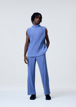 A model wears the HOMME PLISSÉ ISSEY MIYAKE TAILORED PLEATS 1 trousers.