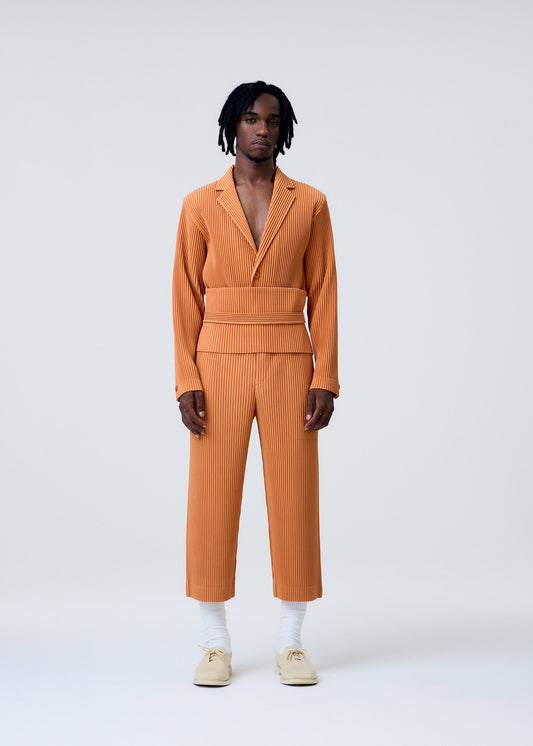A model wears the HOMME PLISSÉ ISSEY MIYAKE TAILORED PLEATS 2 trousers.