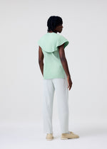 A model wears the HOMME PLISSÉ ISSEY MIYAKE TAILORED PLEATS 3 tailored-pleats-3-trousers-duomo-green.